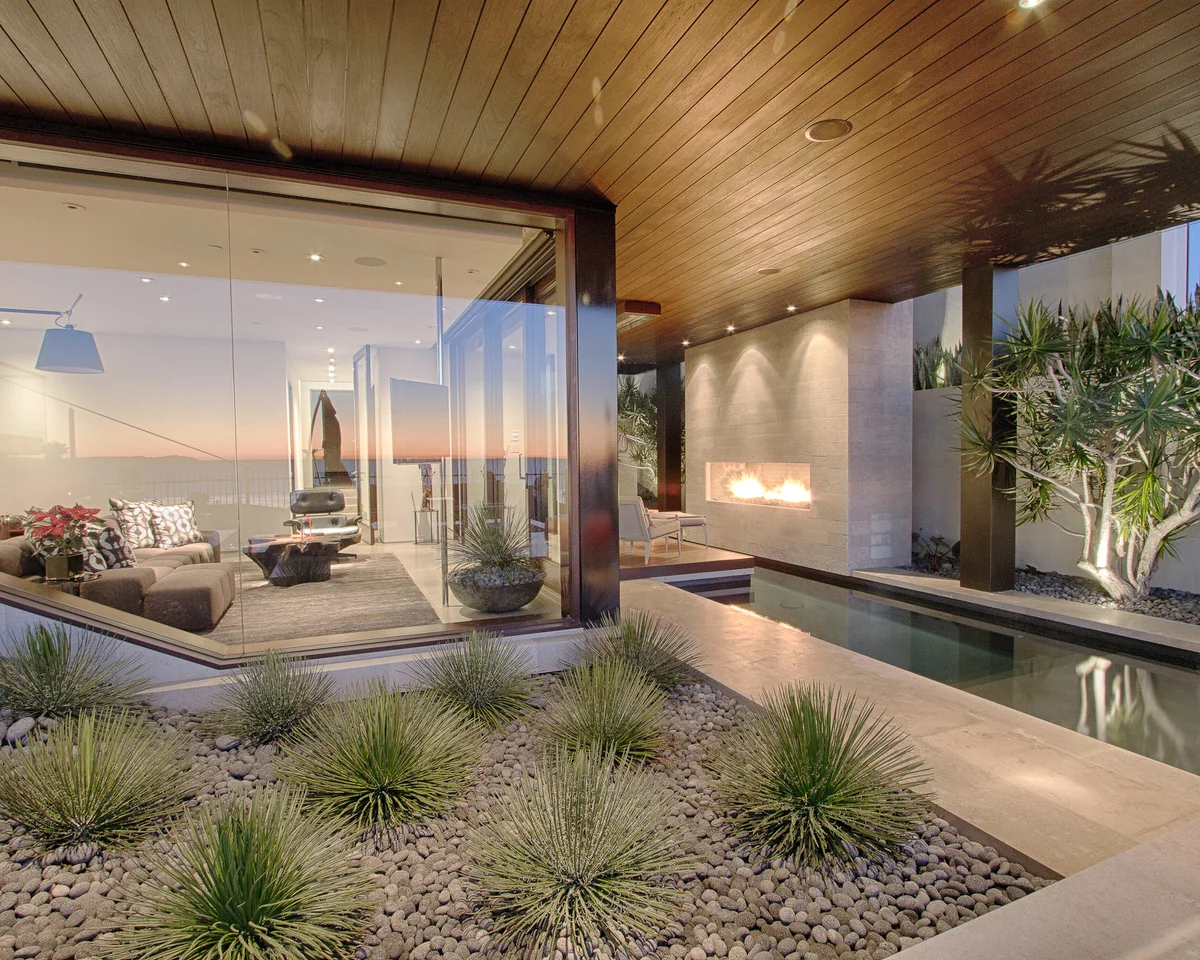 Contemporary courtyard with ornamental grasses, stone paths, and water features