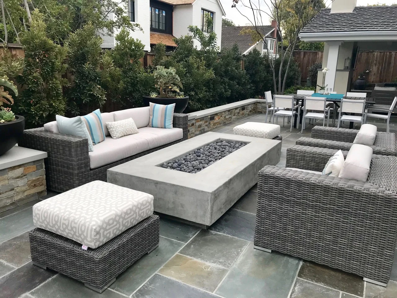 Courtyard seating arranged around a rectangular fire feature