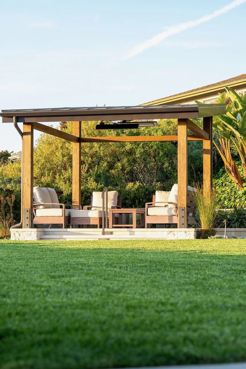 Timber pergola with garden seating beside a green lawn
